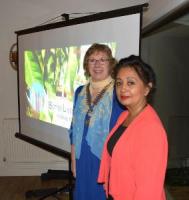 Two ladies standing in front of a screen